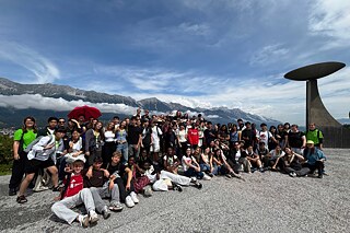 Gruppenfoto, im Hintergrund die Skisprungschanze Innsbruck