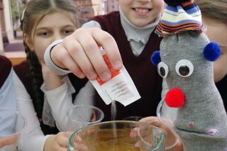 physikalisches Experiment mit Sockenhandpuppe und Grundschülern