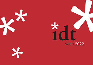 Das Logo der IDT 2022 auf rotem Hintergrund mit stilisierten weißen Sternen.